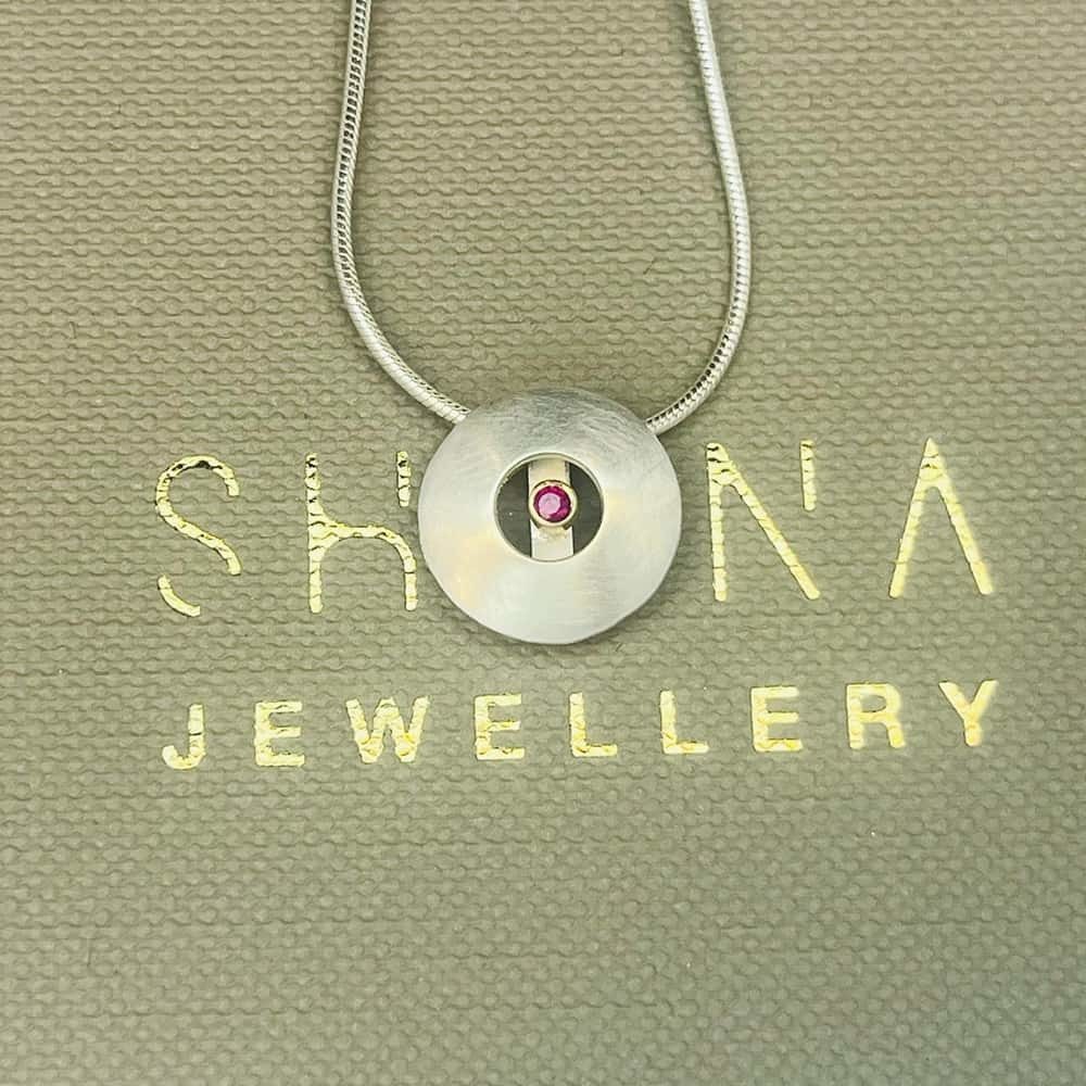 Ruby Orb Necklace Supporting